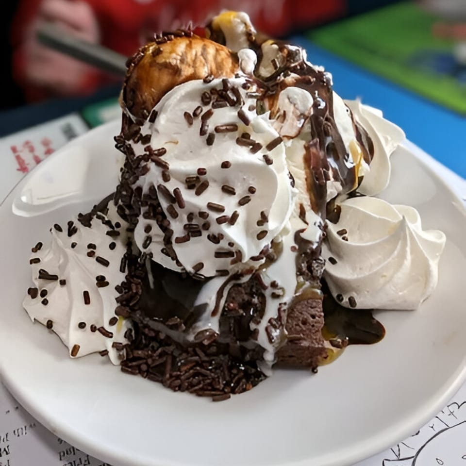 A Southside Diner brownie sundae with ice cream, whipped cream, chocolate syrup, and sprinkles.